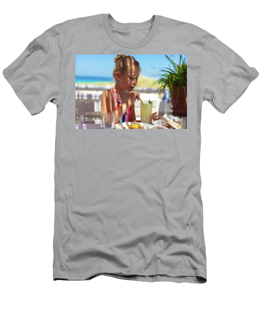 Cute Little Girl Drinking Juice on the Beach Anna Om T-Shirt
