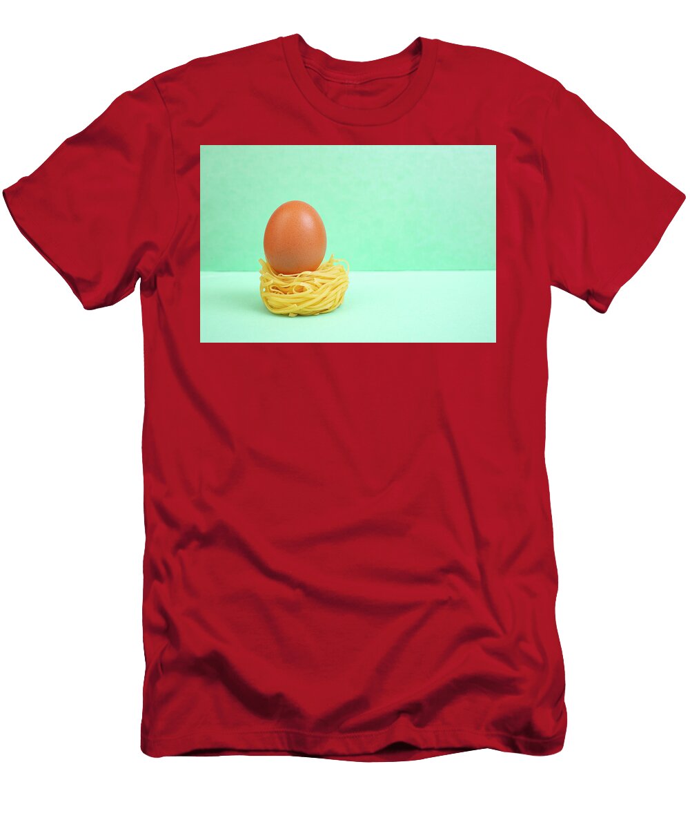 Raw Whole Egg on a Rolled Pasta Nest on Bright Green Background Dorin Puha T-Shirt